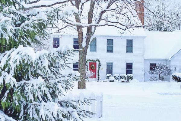 Snowy front yard of a ranch style house