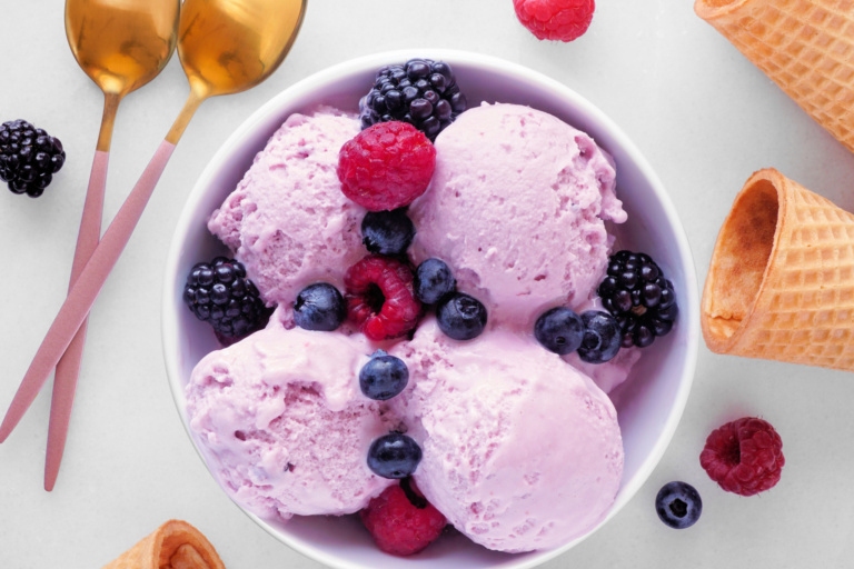 Field berry ice cream, top view with copy space on a marble background
